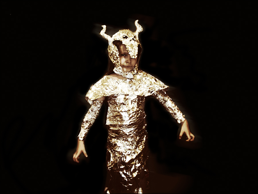 The child experiments with being a golden dragon