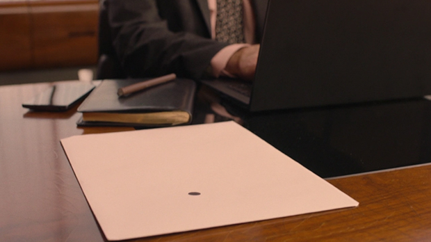 Envelope with black dot